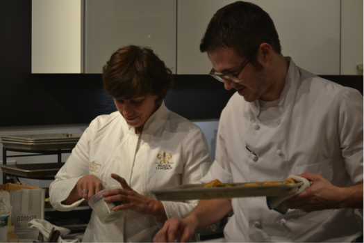 Barbara Lynch and a staff member preparing asparagus wrapped in phyllo pastry