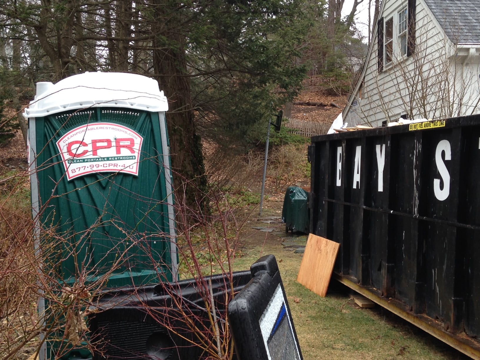 Note how the dark, woodland green of this port-a-potty blends in with its surroundings.