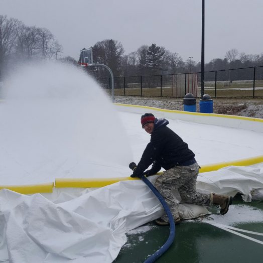 Andy Wrobel filling skating rink