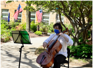 Cellist Seth MacLeod playing in the courtyard