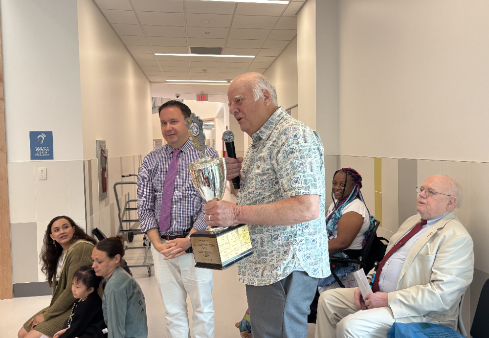 Celebrations Committee's Pete Jones presenting award to Principal Grant Smith at Hardy Elementary School