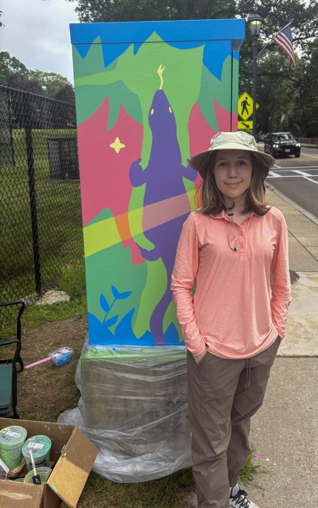 Ellen Kim, with completed traffic box painting in front of Warren Building