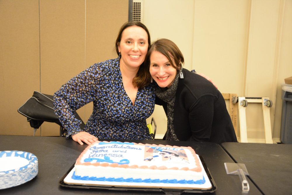 Celebrating with a cake with their book in the frosting